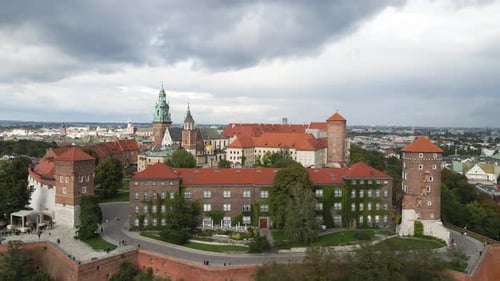 Establishing aerial shot of historic buildings with a grey overcast sky above. Wawel Royal Castle in