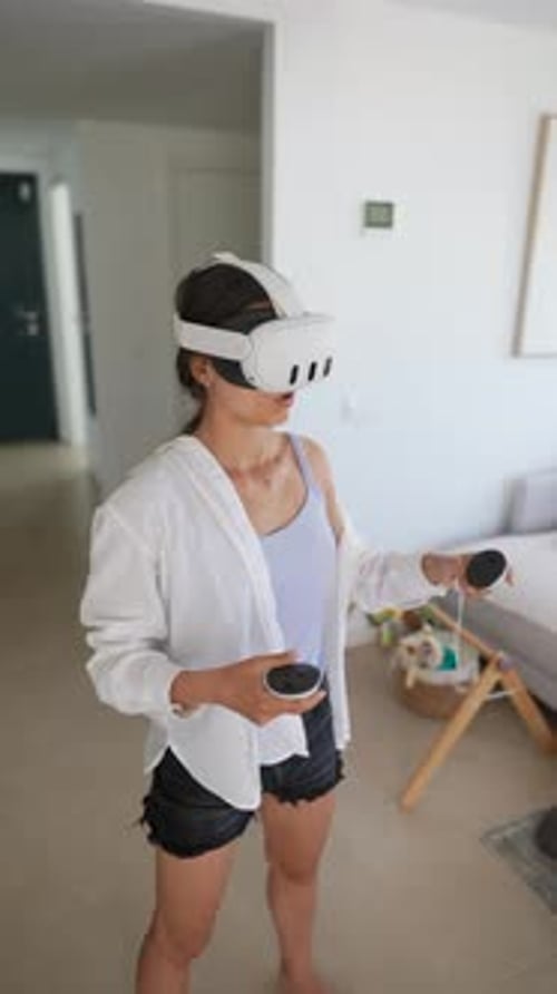 Woman Using VR Headset with Controllers at Home