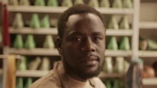Portrait of Young Black Shoemaker in Workshop
