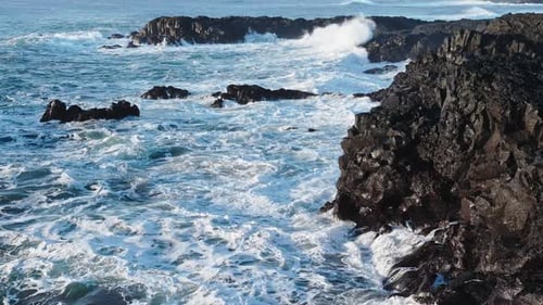 Atlantic Ocean Coast in Windy Weather Large Waves Crashing on Sharp Black Basalt Rocks Coastline in