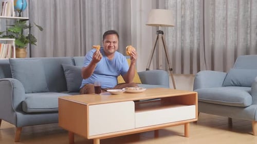 Adult Eats Burger and Fried Chicken at Home