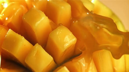 Viscous Mango Juice Poured on Diced Tropical Fruit