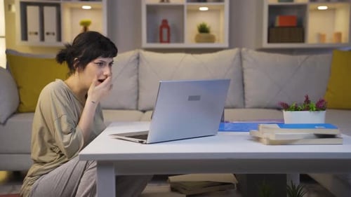 Woman Reacts to Laptop with Shock and Horror