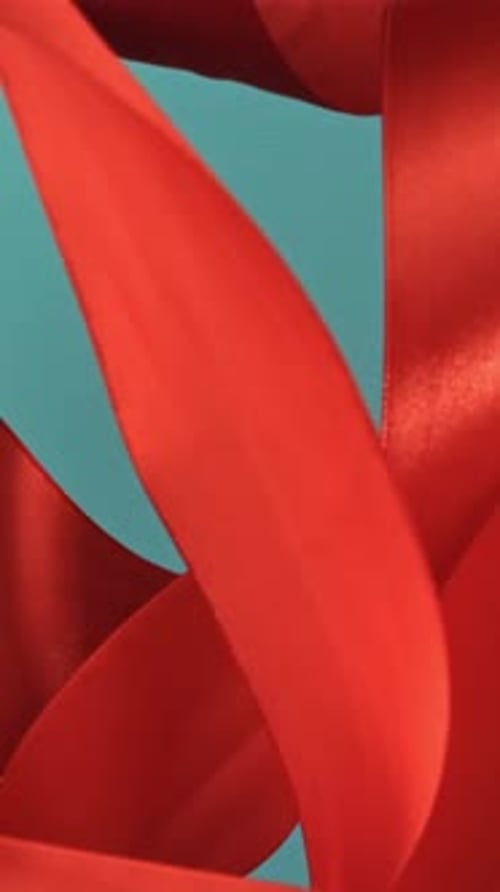 A Red Ribbon Flies on a Blue Background Filmed on a Highspeed Camera at 1000 Fps