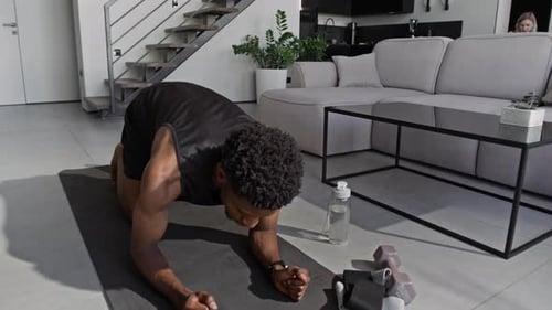 Young Man Doing Plank Exercise on Exercise Mat