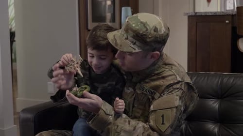 Father In Military Uniform Plays with Son at Home