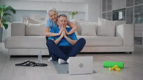 Active Senior Couple Exercising Together at Home
