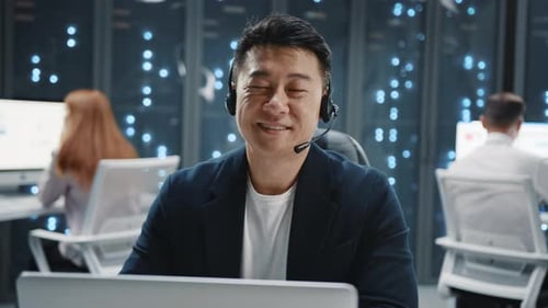 Smiling Man with Headset Working in Data Center
