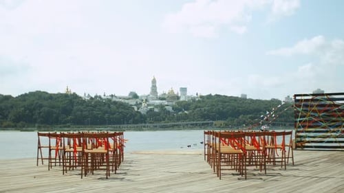 Wedding Decoration Wooden Chairs on the Pontoon Bridge Slow Motion Shot Beautiful Dnipro River on
