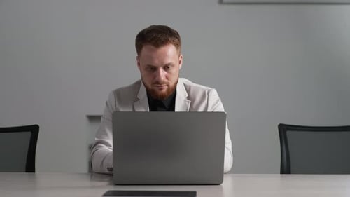 Portrait of Confident Businessman Working on Laptop Computer at Office Looking to Screen with