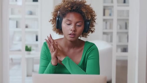 Woman With Headphones on Video Call