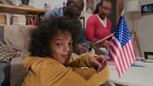Family Prepares American Flags for Fourth of July