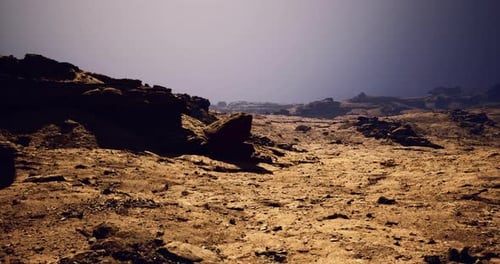 Desolate Landscape with Rocky Formations Under Twilight Sky
