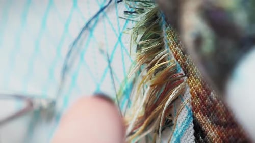 Hands Working on Textile Art Piece