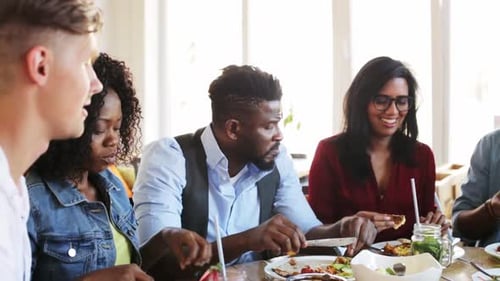 Friends Enjoying Lunch Together at Restaurant Table