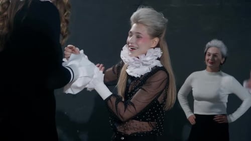 Elegant Women Wearing Ruffled Collars in Costumes