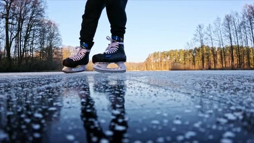 Ice Skater Gliding Backward on Frozen Lake Creating Calm Winter Mood Atmosphere