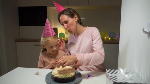 Mother and Child Decorate Birthday Cake Together