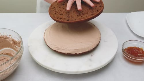 Putting Layer of Cake on Chocolate Frosting