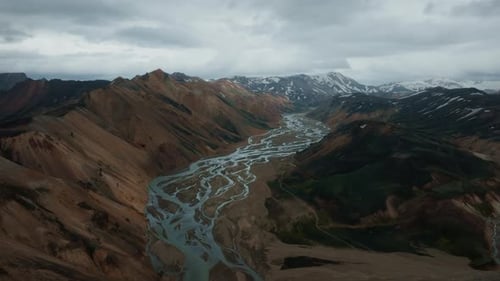 Aerial view of Landmannalaugar mountains with visible river estuary, ice peaks, and clouds. Part 3.