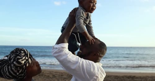 African Parents and Cute Little Son Having Fun Together on the Beach
