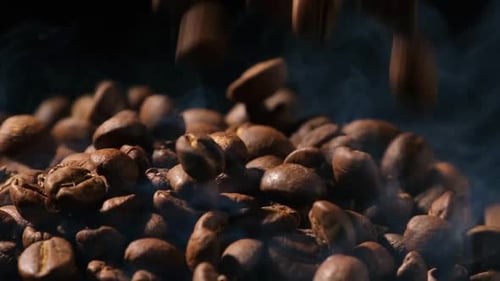 Aromatic Steaming Coffee Beans Falling in Slow Motion