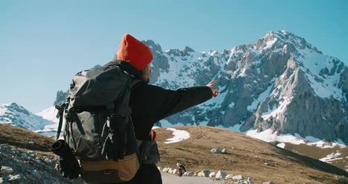 Traveler Man Enjoys of Freedom on Winter Vacation Trip Pointing Way with Hand