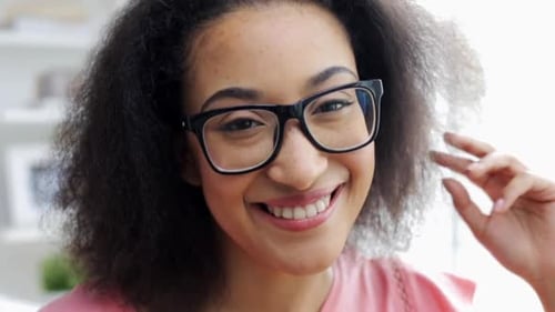 Smiling young woman wearing glasses close up portrait