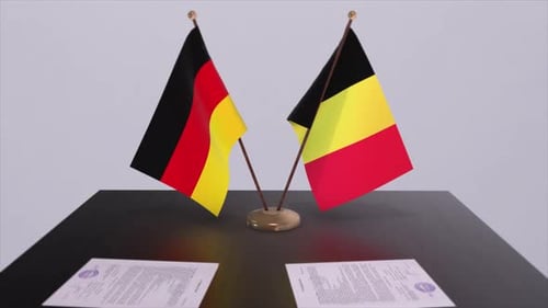 German and Belgian Flags on Table With Paperwork