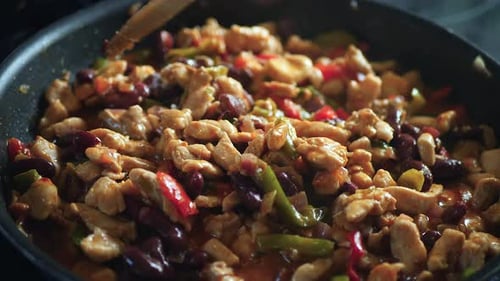 Chicken, Bean, and Pepper Stir-Fry Cooking in Pan