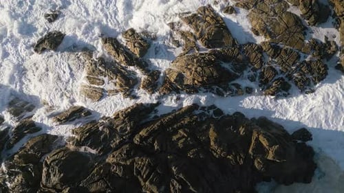 Dangerous Sea Waves Crashes Over Rocks At The Seashore. Topdown, Slow-mo