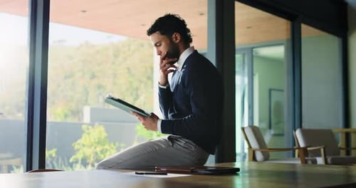 Business, man and thinking with tablet in office for research, proofreading article