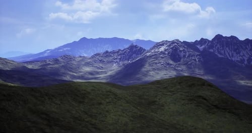Majestic Mountain Landscape Showcasing Rolling Hills and Peaks Under Blue Sky