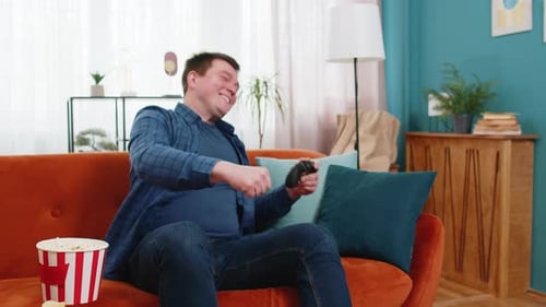 Excited Gamer Plays Video Games at Home