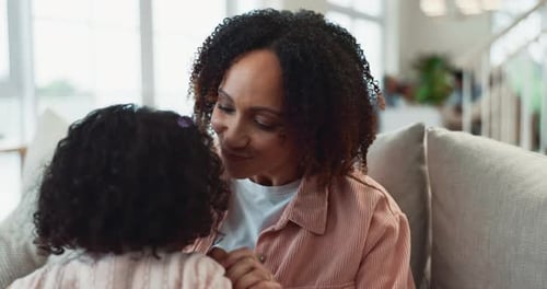 Woman and Child Embrace on Couch