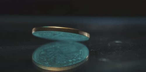 Bitcoin Cryptocurrency Spinning on Reflective Surface