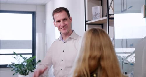 Smiling Man Talking in Modern Office Environment