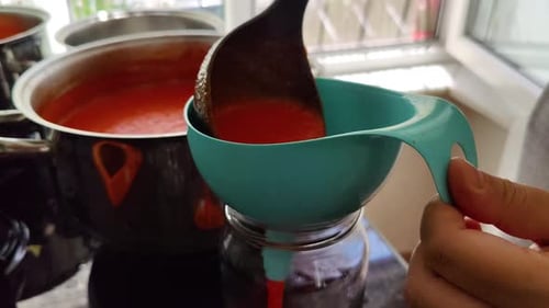 Tomato Sauce Being Canned at Home