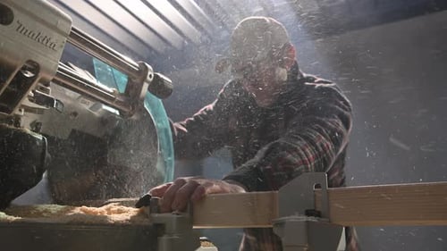 Man Cutting Wood With Powerful Saw Machine