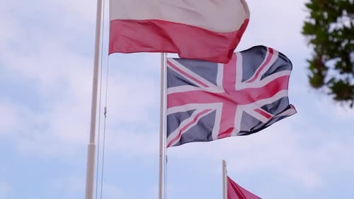 UK Flag Waving Proudly Against Cloudy Sky