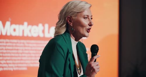 Keynote speaker, marketing and talking with woman at seminar for conference
