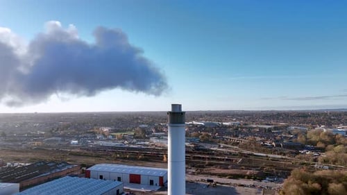 Smokestack Spewing Smoke in Urban Industrial Setting