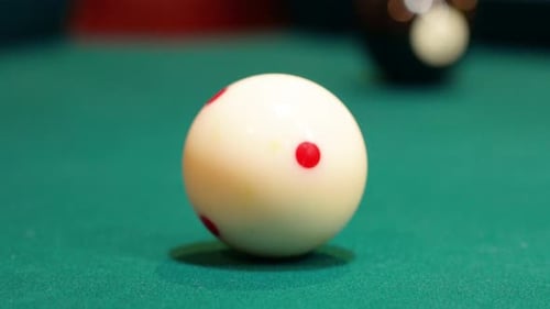 Closeup of Cue Ball Being Shot into the Black 8 Ball and Pocketing it in Corner Hole of a Brunswick
