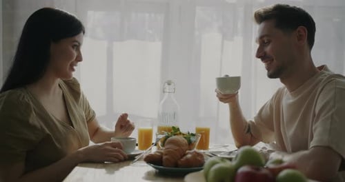 Young Couple Enjoying Breakfast at Home Together