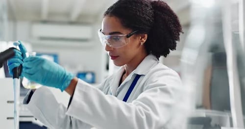 Scientist Working in Modern Laboratory with Pipette