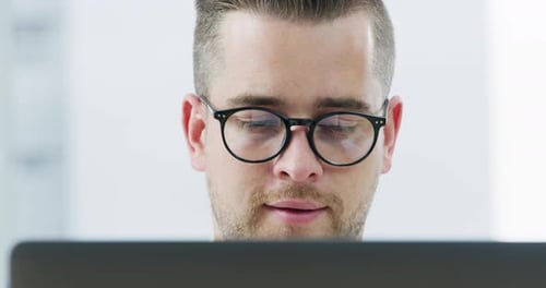 4k video footage of a young businessman working on a computer in an office