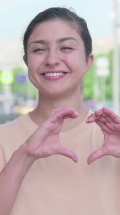 Smiling Woman Makes Heart Gesture, Love Concept