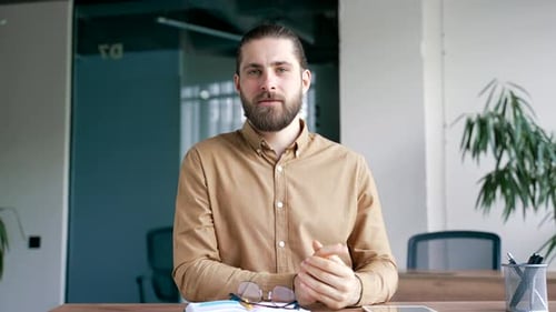 Webcam view. Confident smiling businessman talking on a video call conference looking at camera