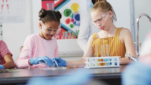 Diverse happy schoolchildren having science class in school lab