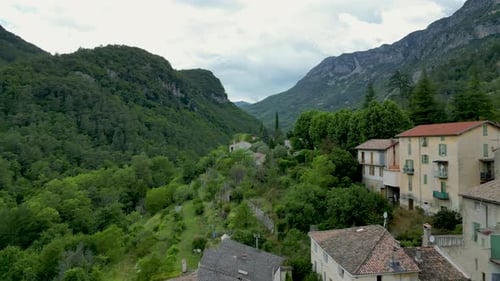Scenic drone shot of terracotta rooftops and cobblestone streets in a tranquil mountain village in f